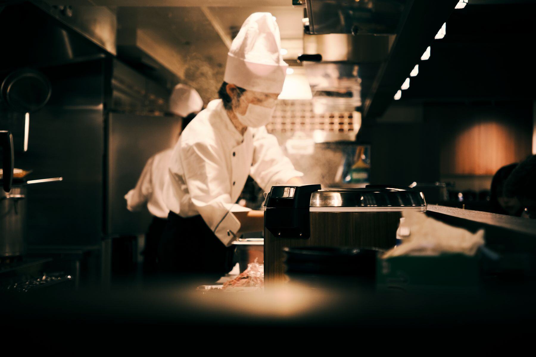 Sushi chef working at a candlelit live station Sushi chef working at a candlelit live station