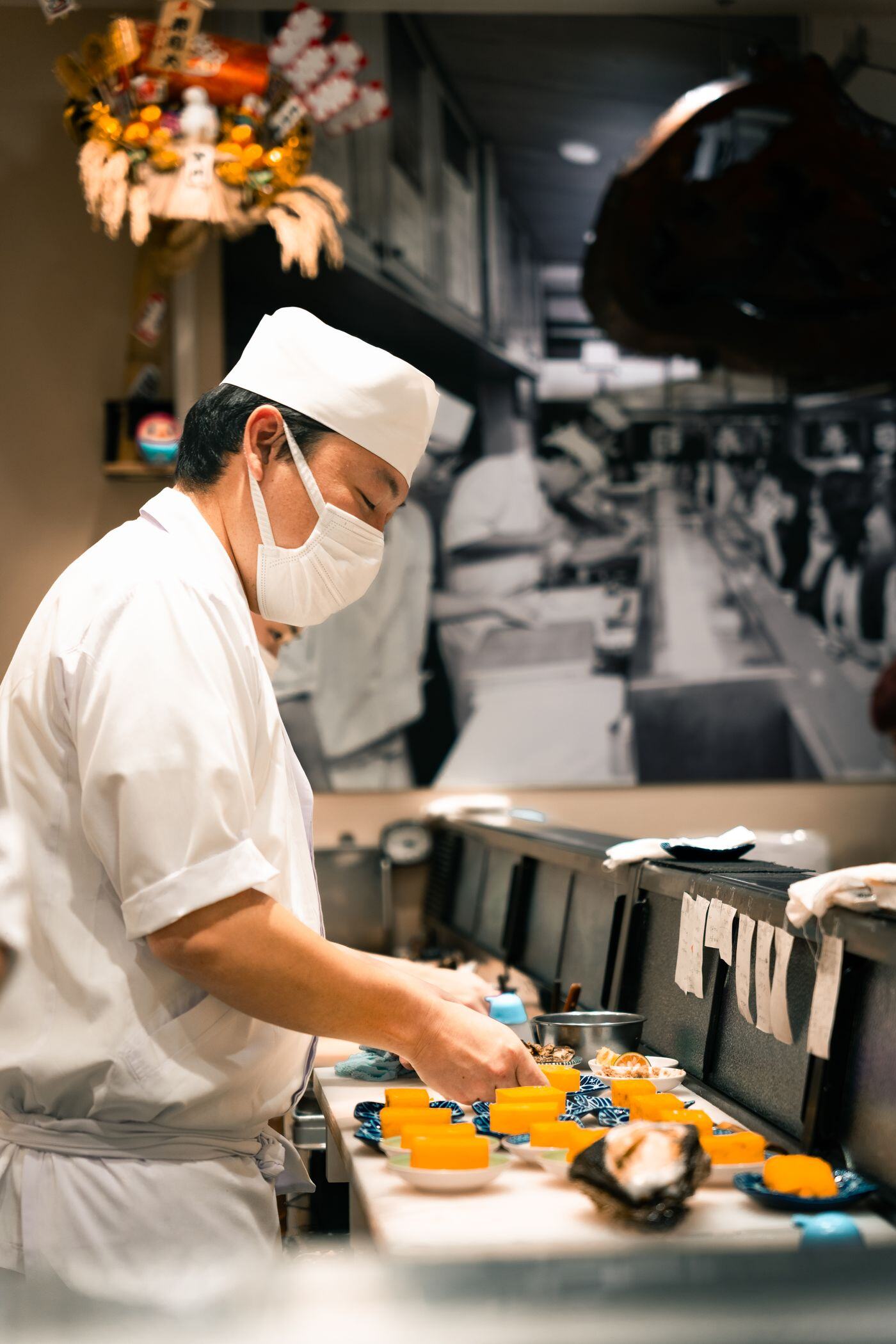Sushi chef forming nigiri at an omakase counter Sushi chef forming nigiri at an omakase counter