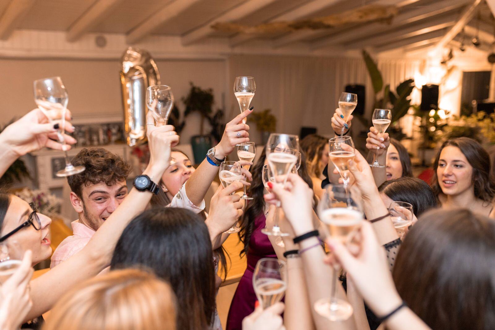 Guests toasting champagne at a holiday party with sushi catering in New York