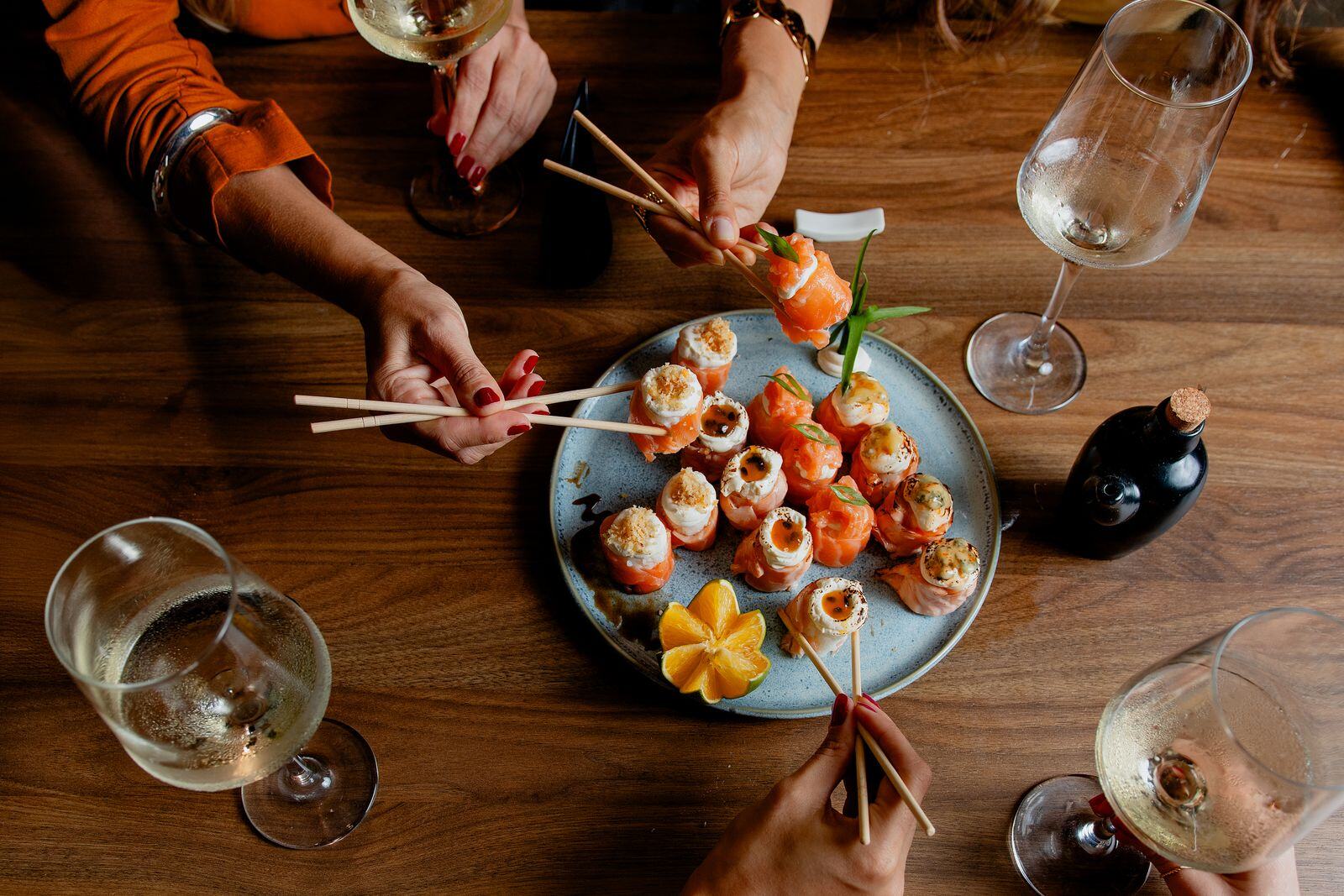 Guests sharing sushi and wine at a private dinner party in Manhattan