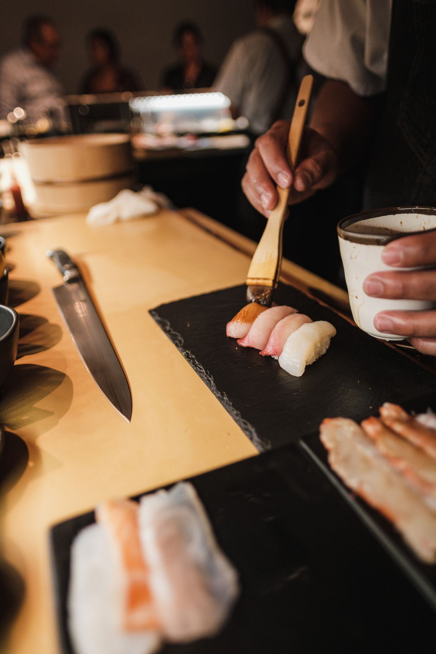 One piece at a time Nigiri served piece by piece to guests at a live sushi station