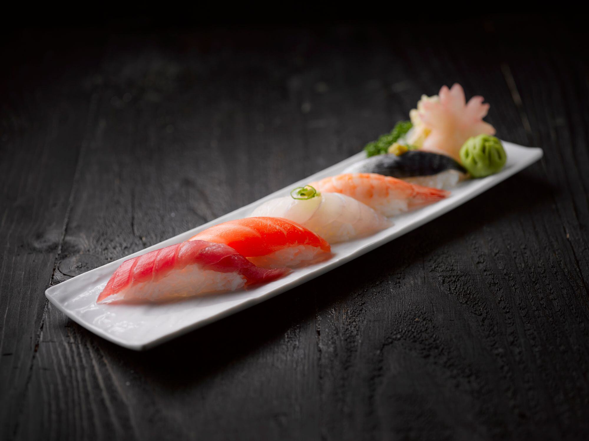 Omakase nigiri selection on black wood for nyc sushi catering Omakase nigiri selection on black wood for NYC sushi catering